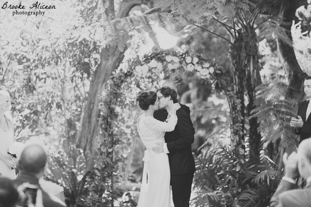 bride and groom first kiss photos, san diego botanical garden wedding ceremony